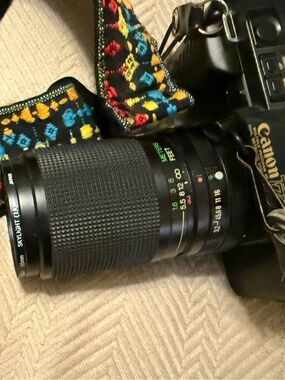 Canon T-70 35mm film camera with 35mm-105mm Zoom Lens with Multicolor Strap